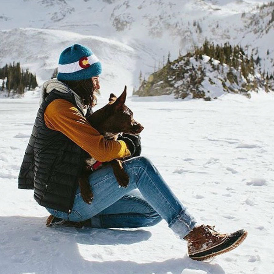 woman wearing royal blue colorado flag knitted beanie hat