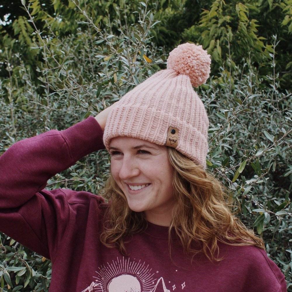 pink knitted womens beanie with pom pom