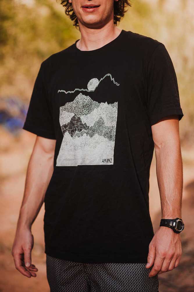 man wearing black ascend mountain tee