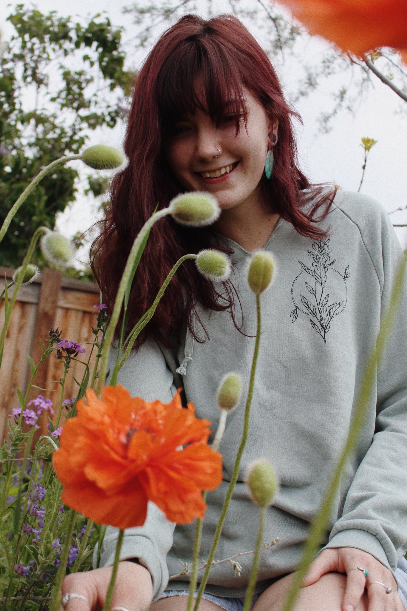 woman with flowers with sage green hoodie