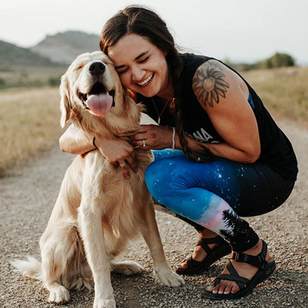 woman wearing wanderlust leggings with dog 