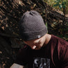 man outside wearing grey ahab knitted beanie and maroon camping shirt
