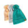 three knitted womens beanies with pom pom