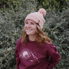 pink knitted womens beanie with pom pom