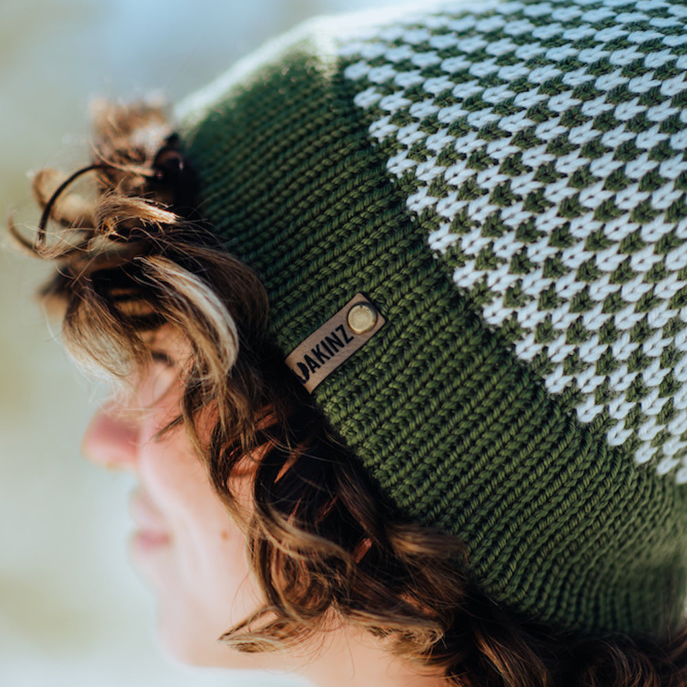 girl wearing green and cream bristlecone knitted beanie