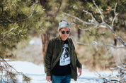 man wearing green flannel, colorado live free tee, and Jackson trio knitted beanie