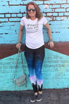 woman wearing wanderlust leggings in front of a mural 